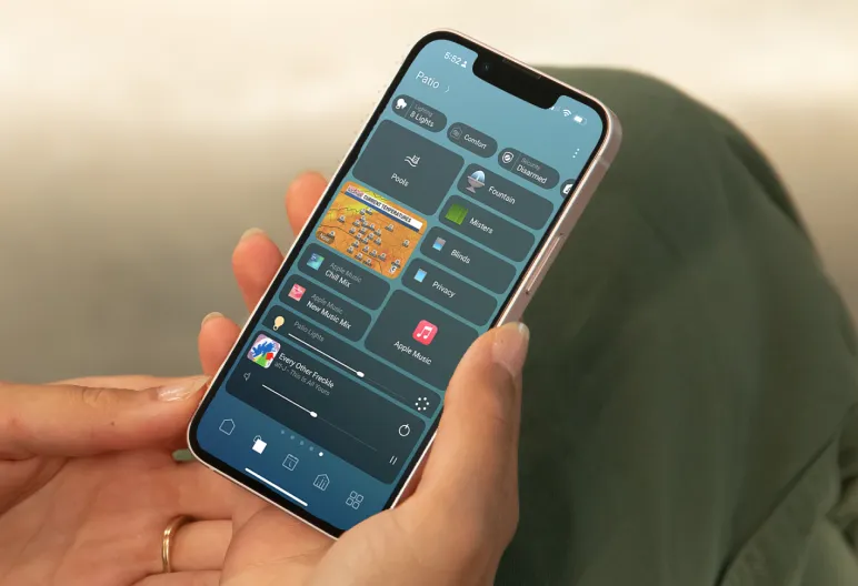 Homeowner using the Control4 app to manage outdoor home functions