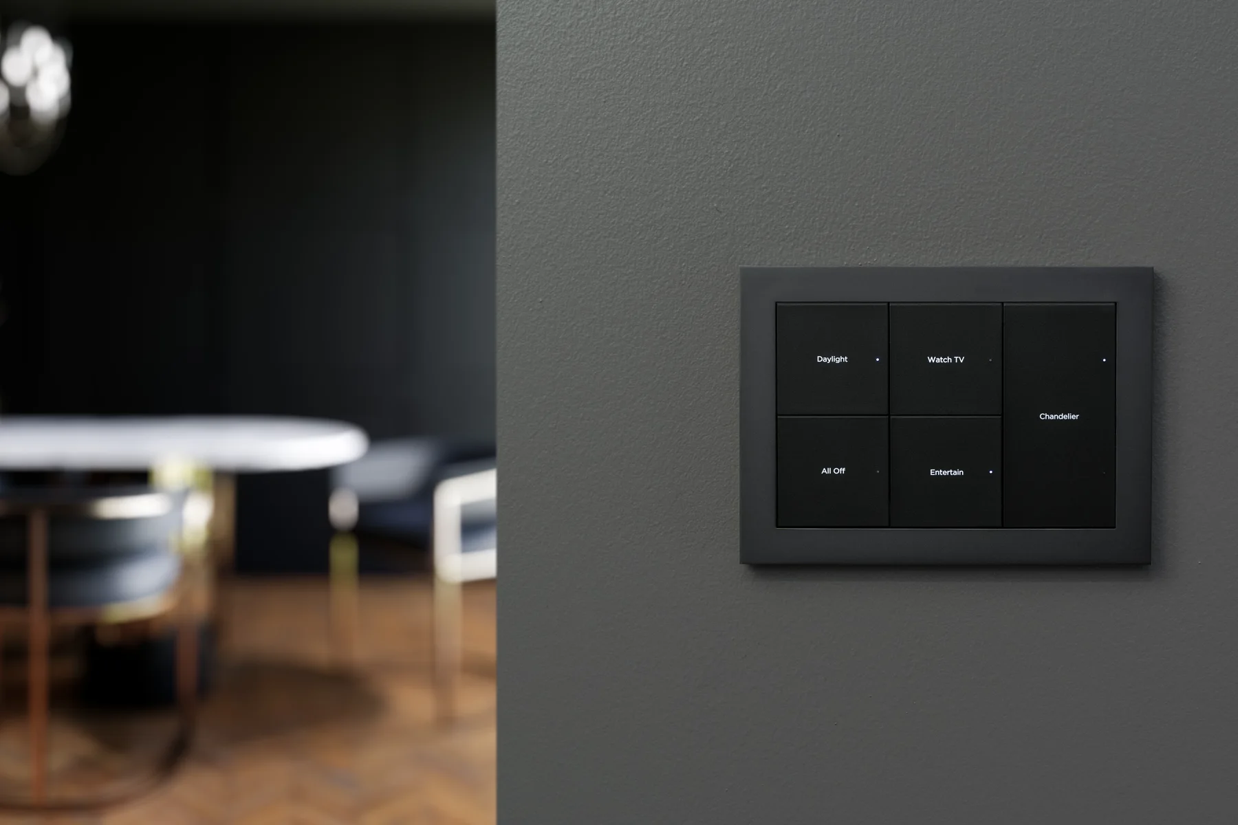 Three-gang Lux by Control4 lighting keypad installed on a dark wall