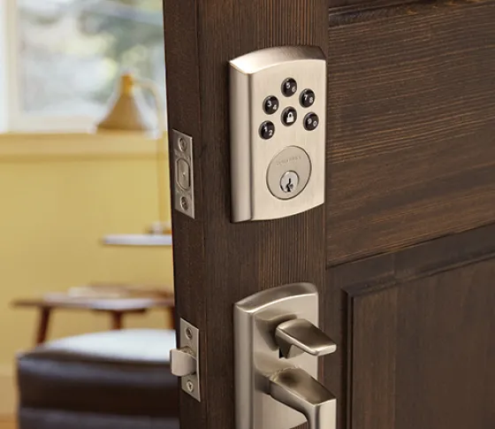 Baldwin keypad smart lock on a dark wood entry door