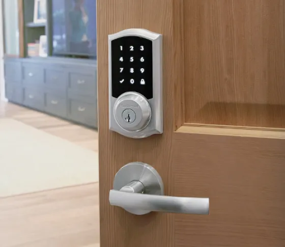 Kwikset touchscreen smart deadbolt on a wood door
