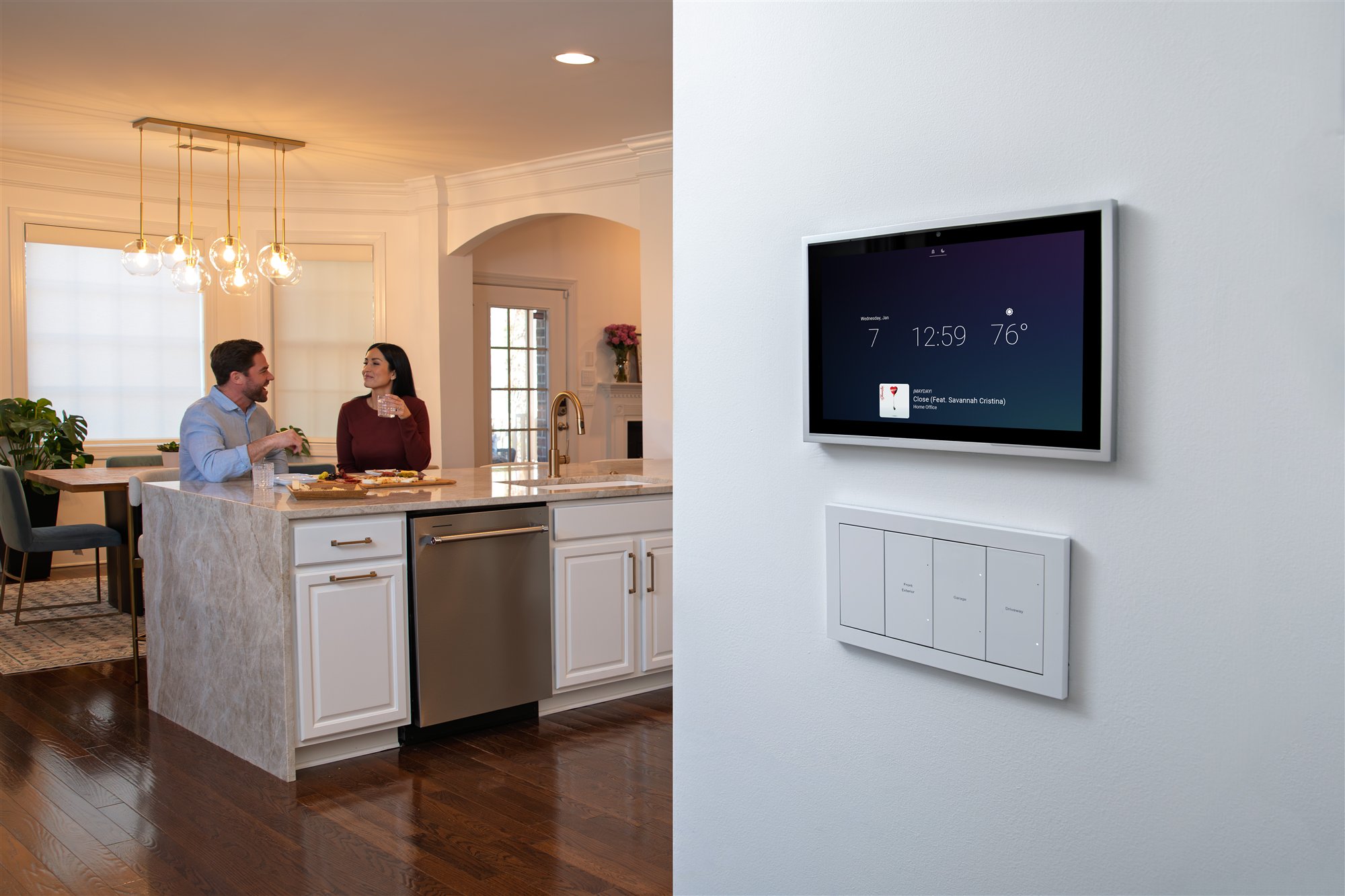 Control4 T5 in-wall touchscreen installed beside matching Lux lighting controls in a kitchen