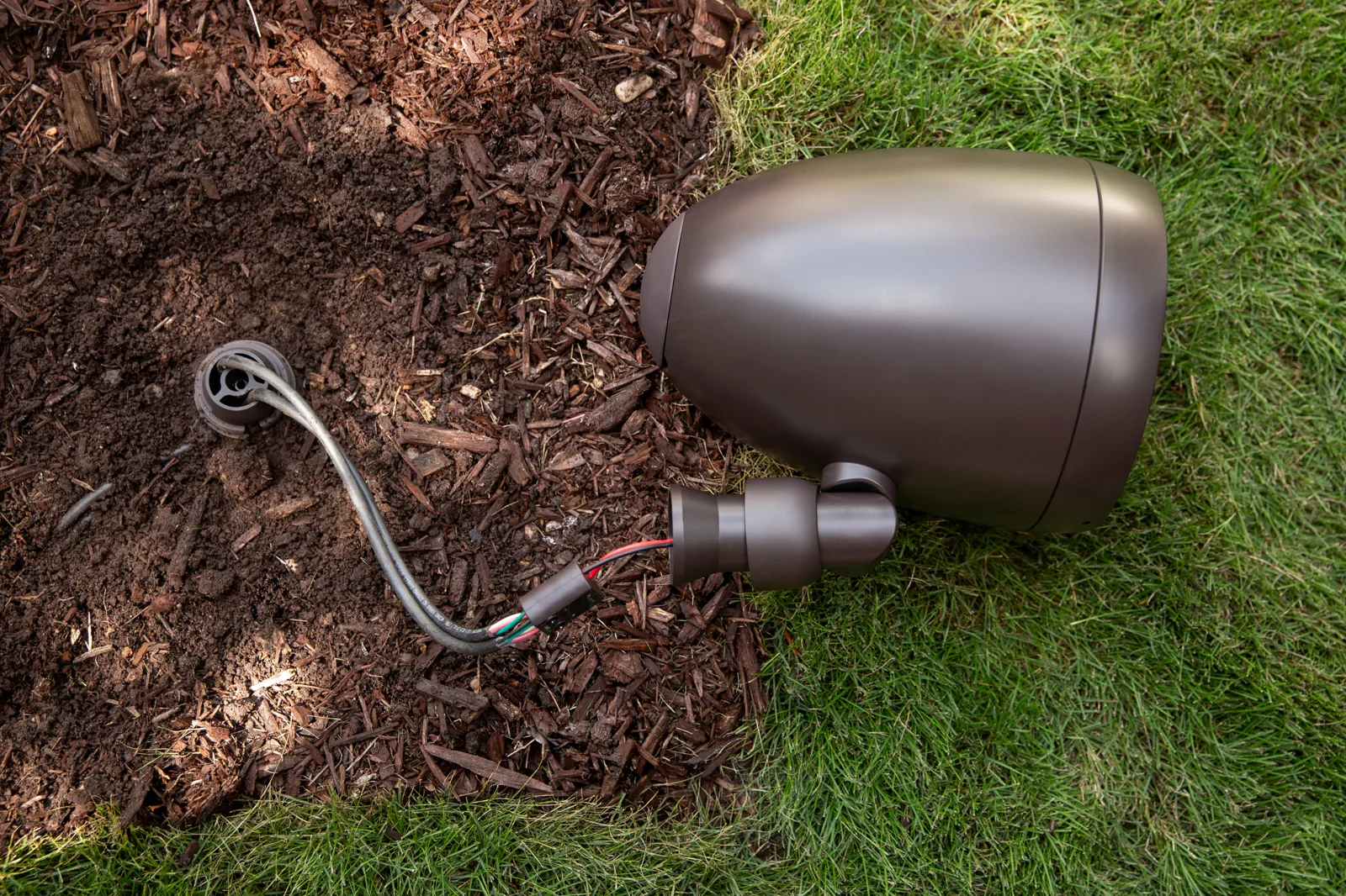Episode landscape speakers and buried subwoofer installed outdoors