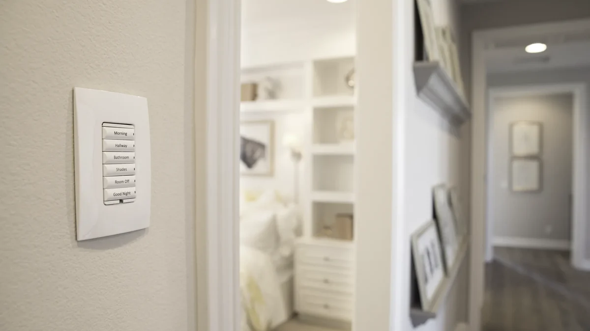 Engraved Control4 keypad installed beside a bedroom hallway