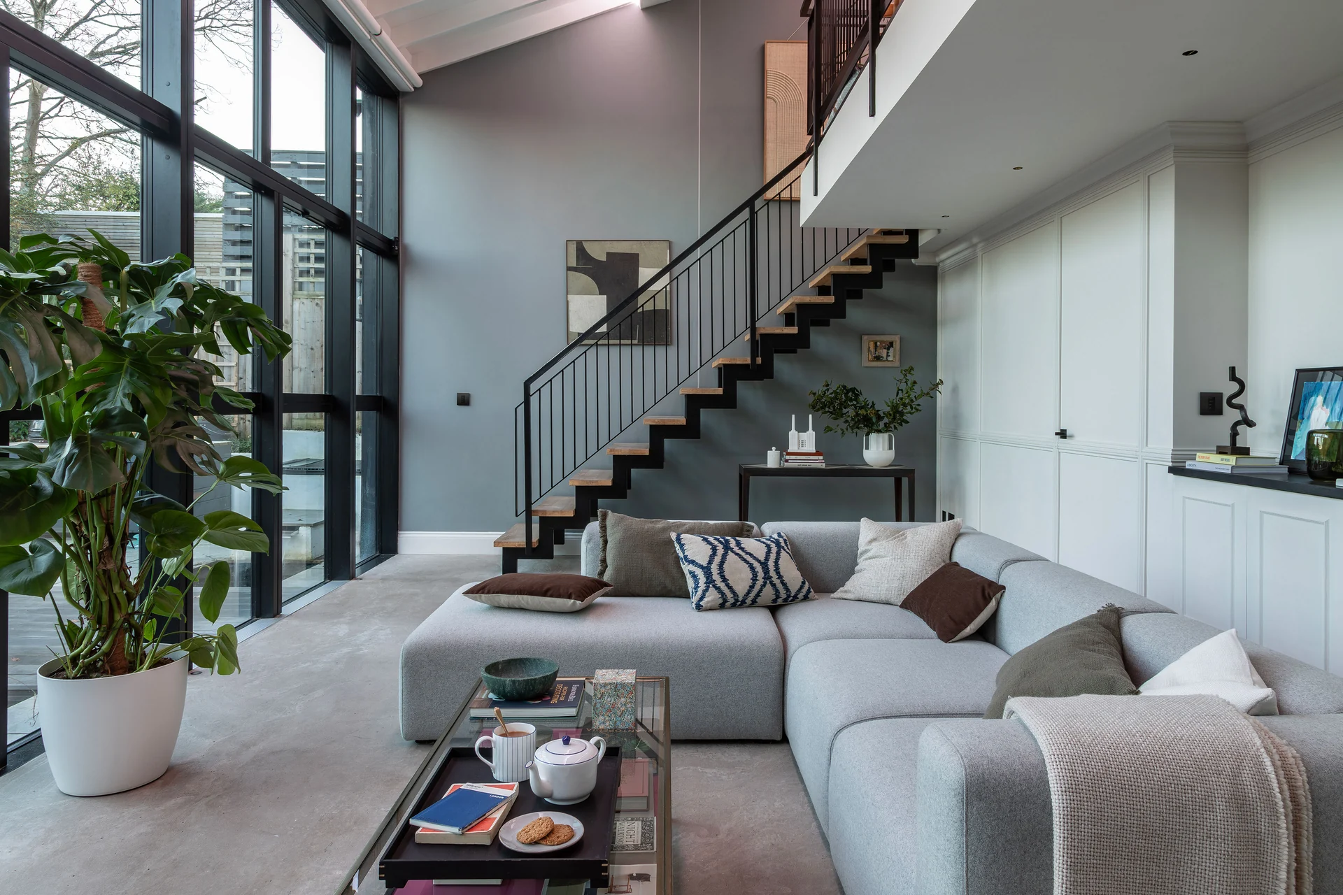 Modern living room with Lutron lighting controls and roller shades