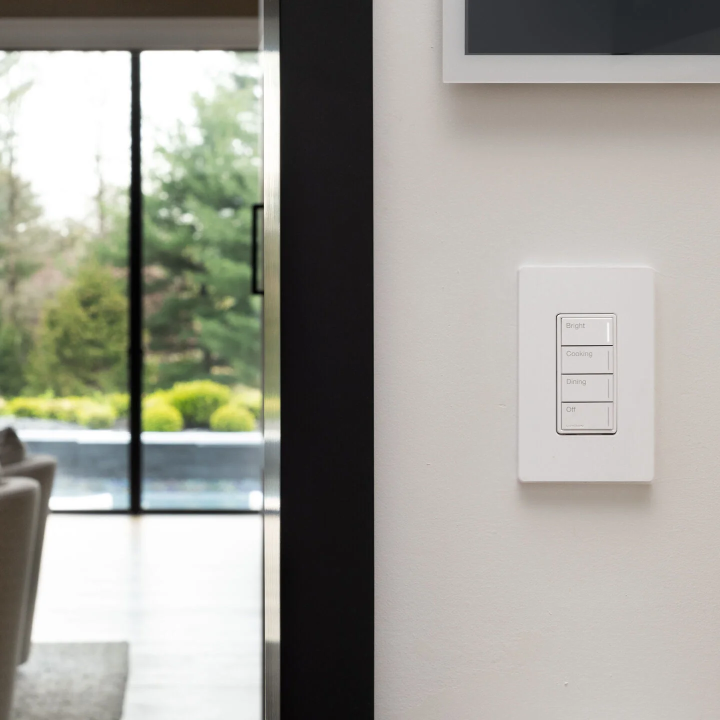 White Lutron Sunnata keypad installed in a finished living space