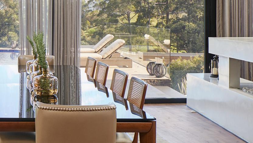 Motorized drapery framing a large dining-room opening
