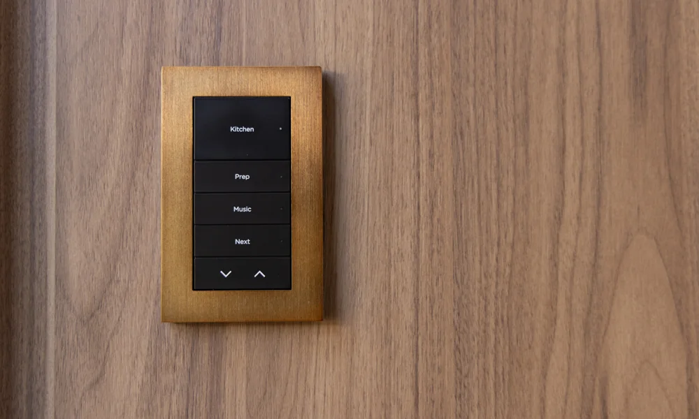 Bronze Lux by Control4 engraved keypad installed on a wood wall
