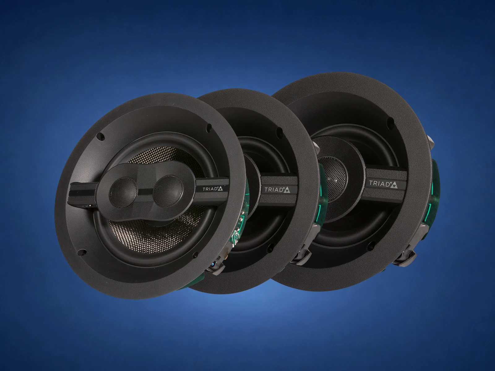 Triad in-ceiling speaker isolated on a blue studio background