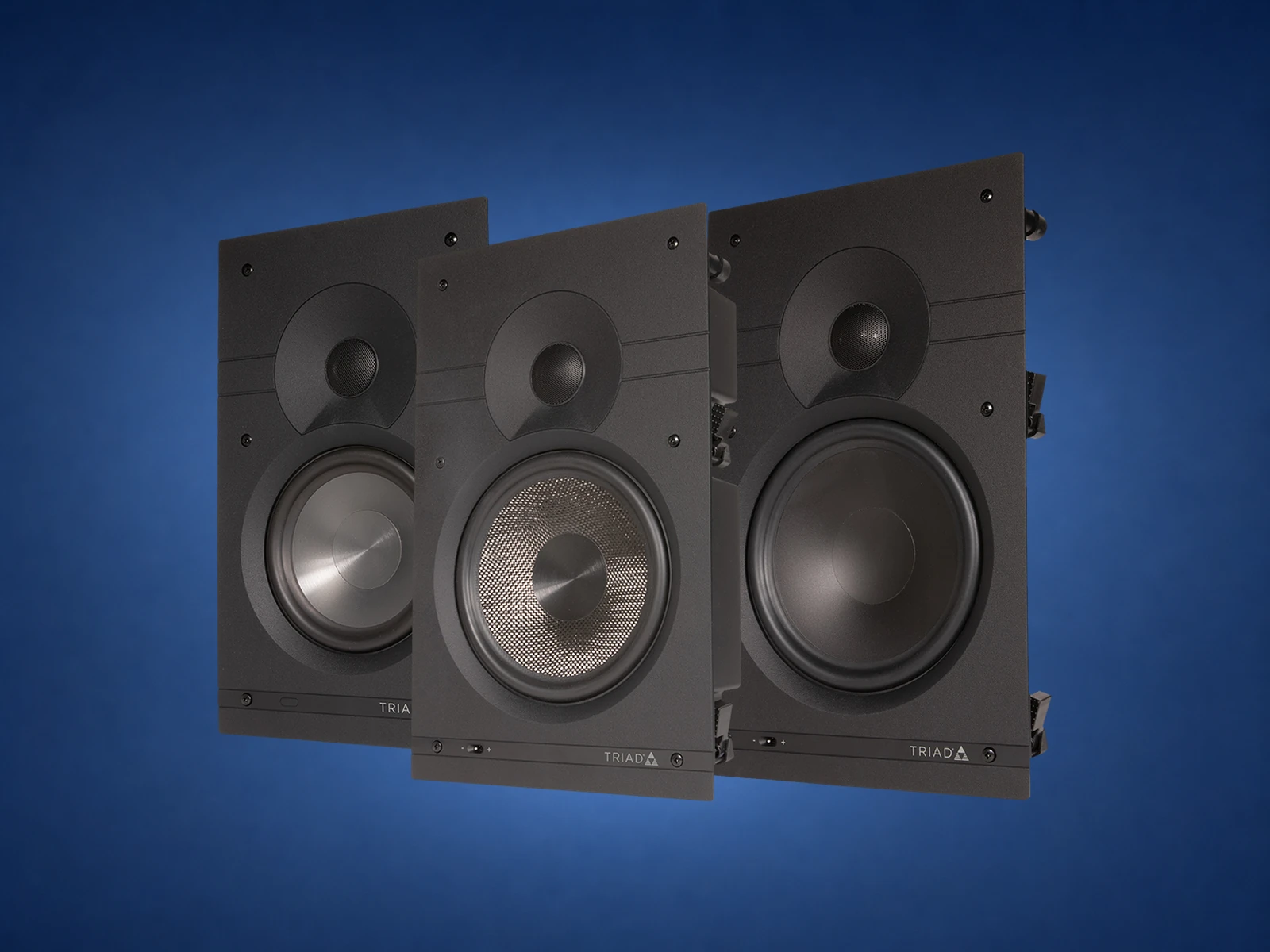 Triad in-wall speaker isolated on a blue studio background