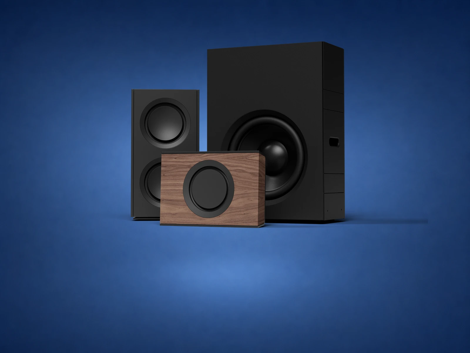 Triad in-room, in-wall and compact subwoofer models shown together on blue