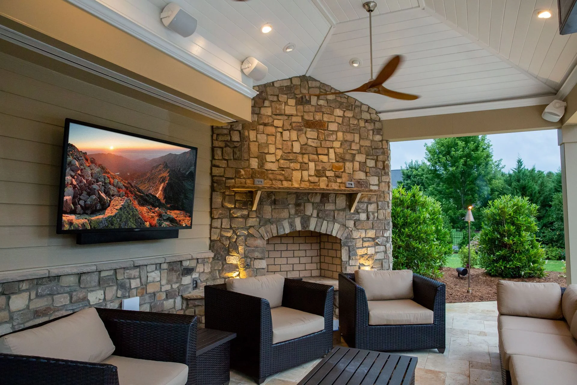 Outdoor TV and surround audio system installed for a backyard entertainment area