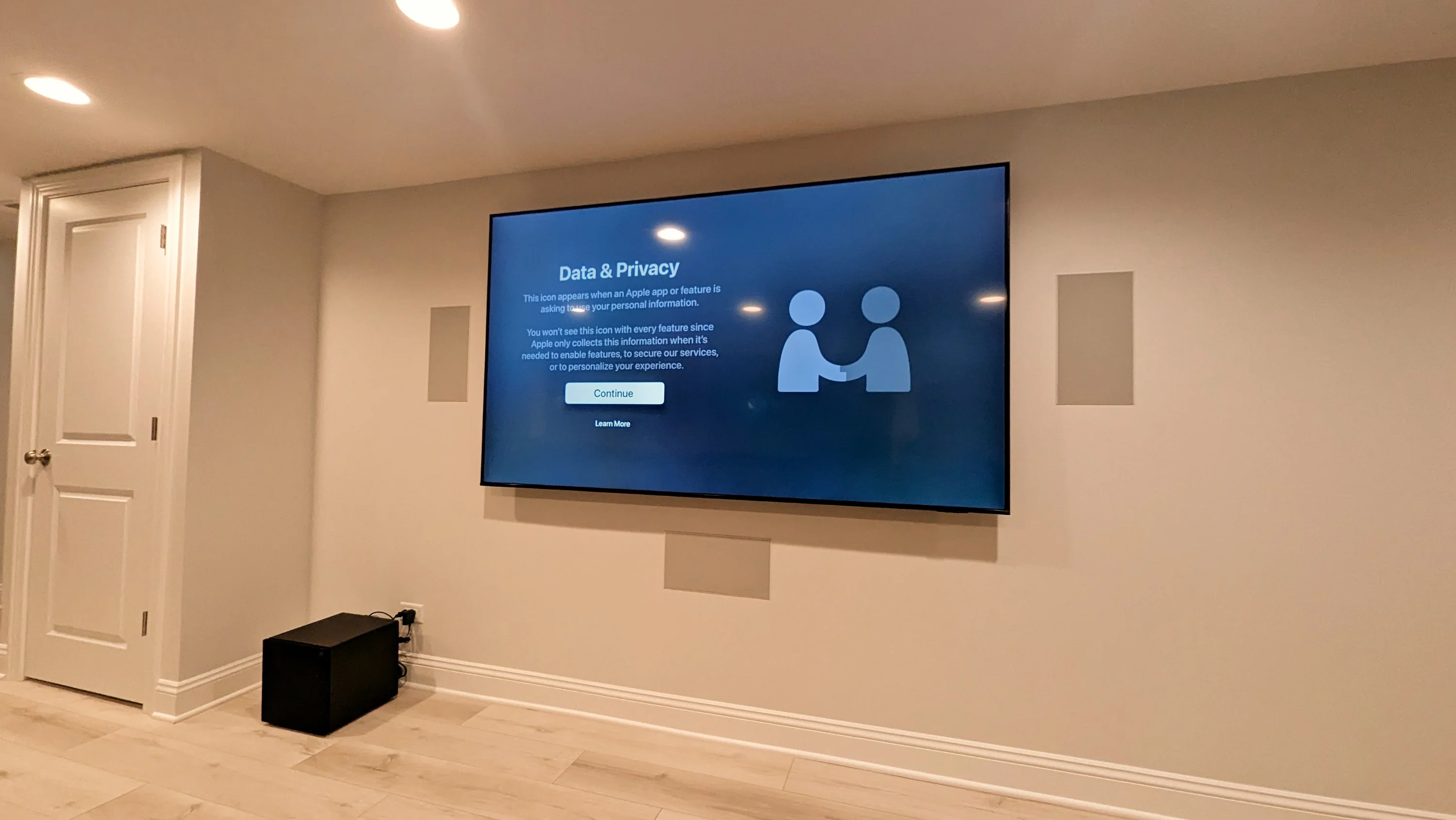 Completed contemporary home theater build with projector, speakers, and media gear