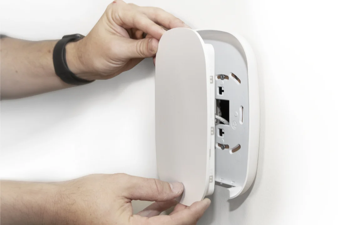 Technician installing a whole-home WiFi access point