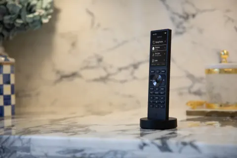 Control4 remote staged on a kitchen counter