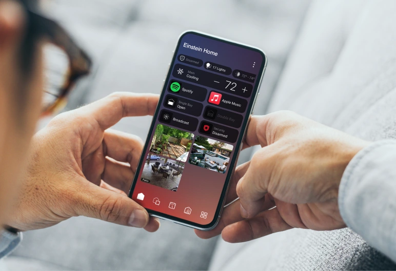Person holding a phone displaying the Control4 X4 app